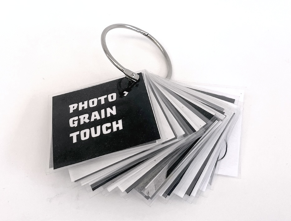 a metal ring with a set of black cards on it